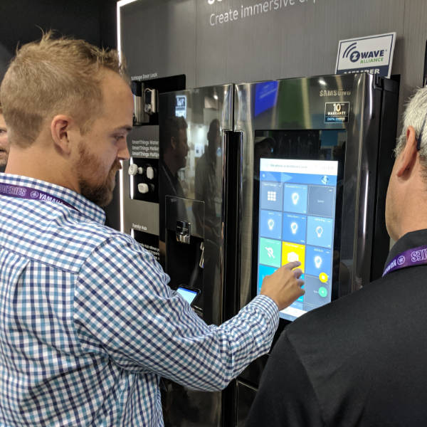 An man explaining SharpTools smart home dashboard interface to another.